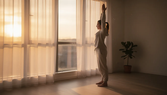Woman waking and stretching in front of window